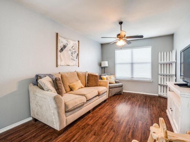 living area featuring dark wood-style floors, ceiling fan, and baseboards