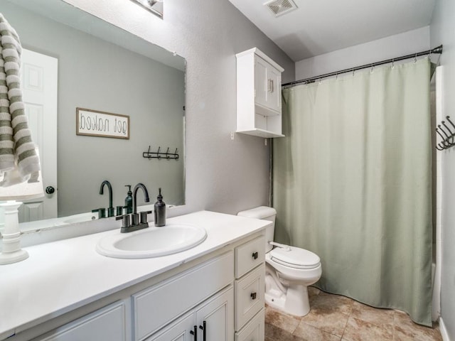 bathroom featuring toilet, vanity, visible vents, and a shower with curtain