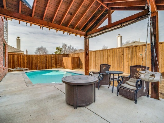 view of swimming pool featuring a fenced in pool, a patio area, and a fenced backyard