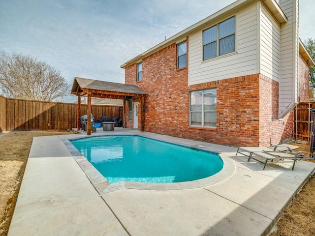 view of swimming pool featuring a fenced in pool, a fenced backyard, a patio, and a gazebo