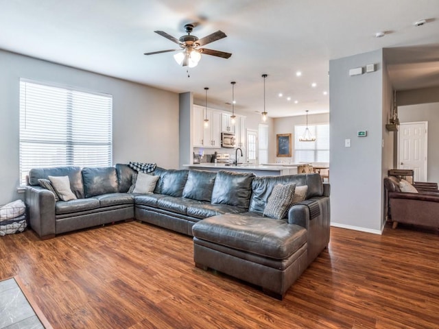 living area featuring a ceiling fan, recessed lighting, dark wood finished floors, and baseboards