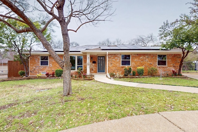 single story home featuring brick siding, a front lawn, and fence