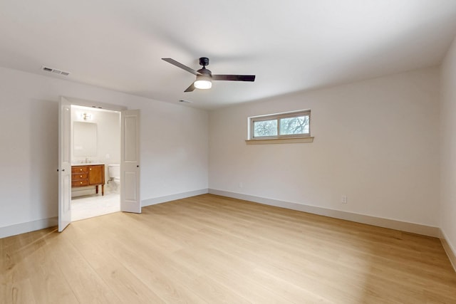 unfurnished bedroom featuring ceiling fan, light wood-type flooring, visible vents, and baseboards