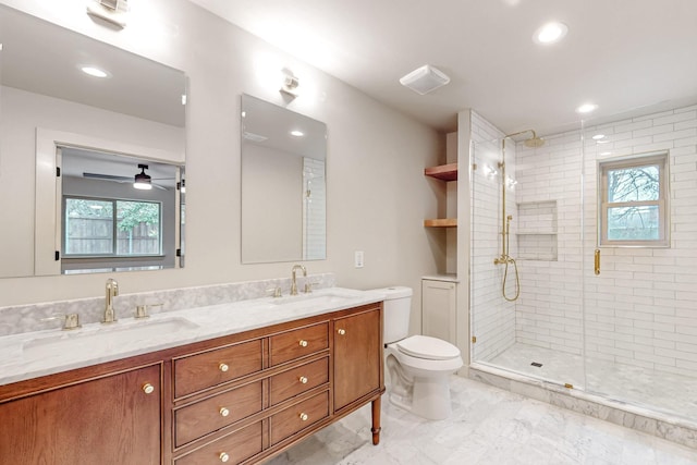 full bathroom with a sink, a shower stall, toilet, and double vanity