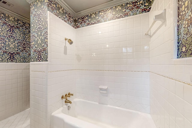 full bath with a wainscoted wall, tile walls, visible vents, tub / shower combination, and wallpapered walls