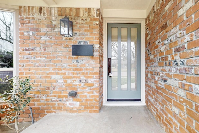 entrance to property with brick siding