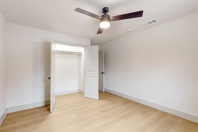 unfurnished bedroom with a ceiling fan, visible vents, baseboards, a closet, and light wood-type flooring