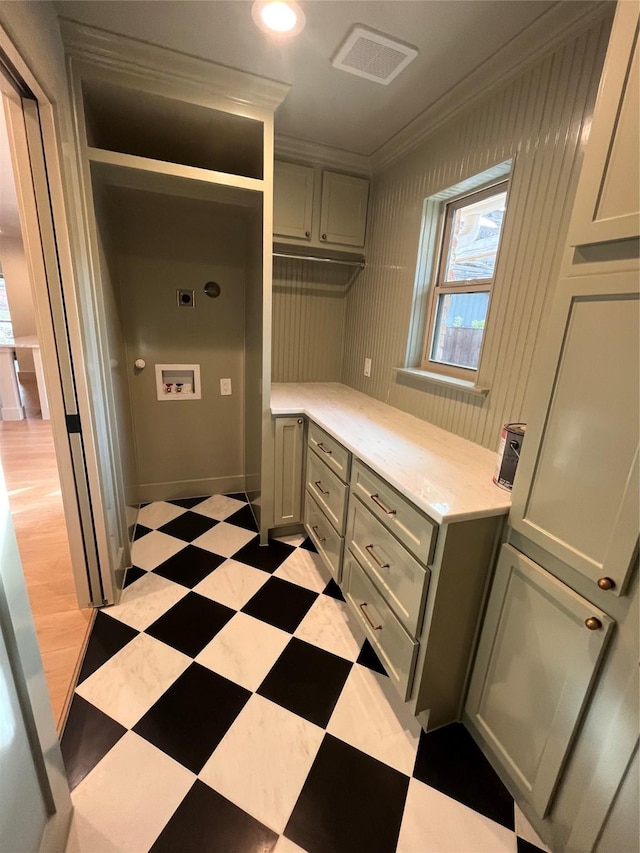 interior space featuring visible vents, ornamental molding, hookup for an electric dryer, light floors, and washer hookup