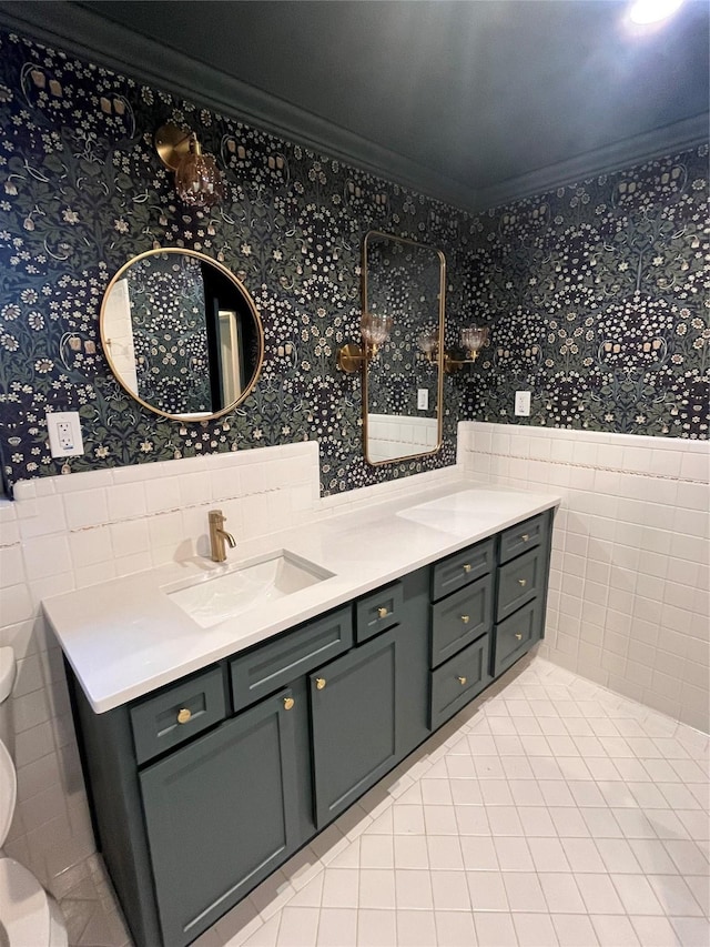 bathroom featuring a wainscoted wall, ornamental molding, toilet, and wallpapered walls