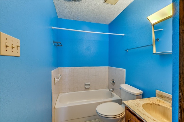 bathroom featuring a tub to relax in, a textured wall, toilet, a textured ceiling, and vanity