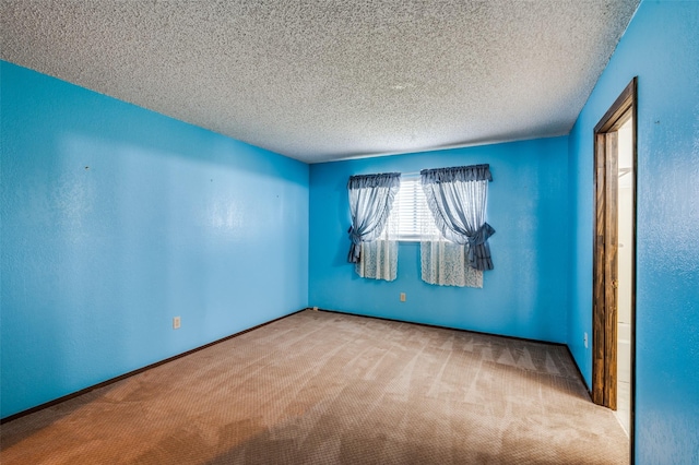 unfurnished room with carpet floors and a textured ceiling