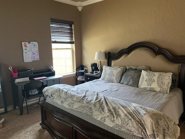 carpeted bedroom featuring ornamental molding and a textured wall