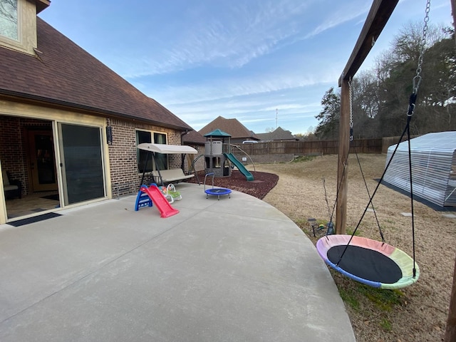 view of patio / terrace with a playground and a fenced backyard