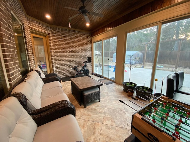 sunroom with wooden ceiling and ceiling fan