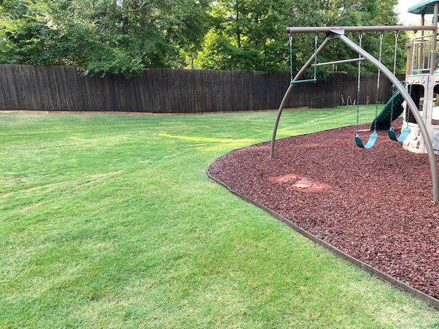 view of yard with a playground and fence