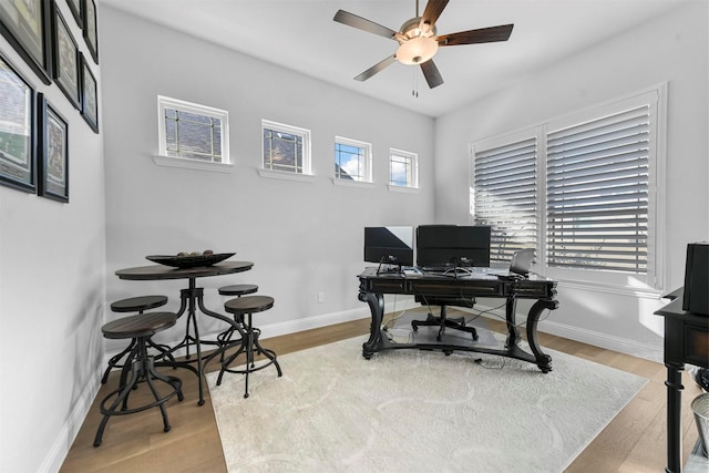 office with light wood-style floors and baseboards