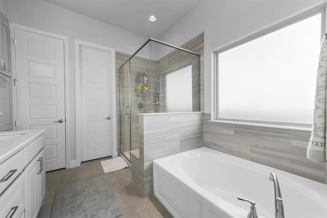 full bathroom featuring a garden tub, recessed lighting, a shower stall, vanity, and tile patterned flooring