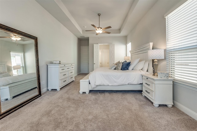 1612 Olympia Ave, Corinth, TX 76208 - bedroom featuring a tray ceiling, light carpet, baseboards, and ceiling fan