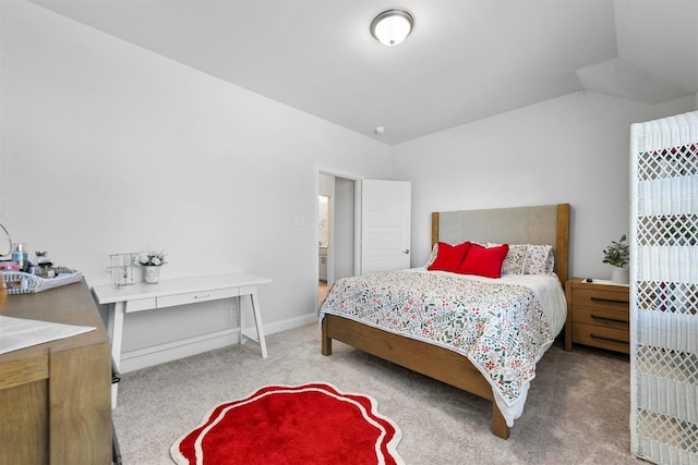 bedroom with light carpet, baseboards, and vaulted ceiling