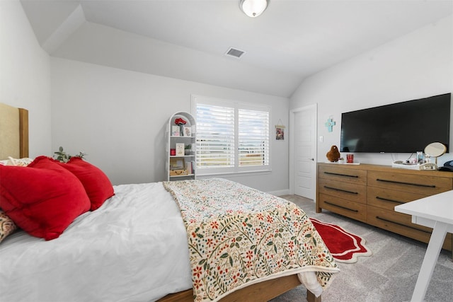 bedroom with light colored carpet, visible vents, lofted ceiling, and baseboards