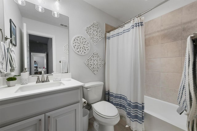 full bath featuring toilet, shower / bathtub combination with curtain, visible vents, and vanity