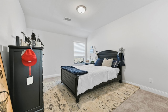 bedroom featuring visible vents, light carpet, and baseboards