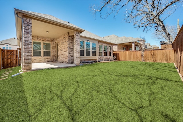 1612 Olympia Ave, Corinth, TX 76208 - rear view of property featuring a lawn, a patio, a fenced backyard, a shingled roof, and brick siding