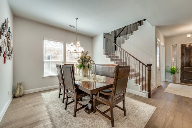 1612 Olympia Ave, Corinth, TX 76208 - dining room featuring visible vents, an inviting chandelier, wood finished floors, and stairs