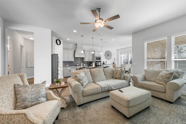 living room featuring ceiling fan, baseboards, wood finished floors, and recessed lighting