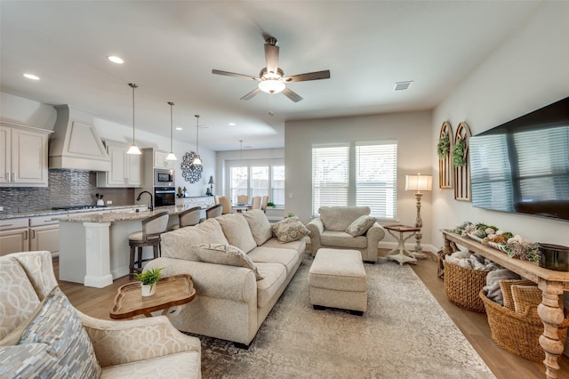 1612 Olympia Ave, Corinth, TX 76208 - living area featuring light wood-type flooring, visible vents, recessed lighting, baseboards, and ceiling fan