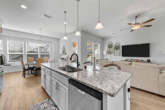 kitchen with light wood-style floors, visible vents, a sink, and stainless steel dishwasher