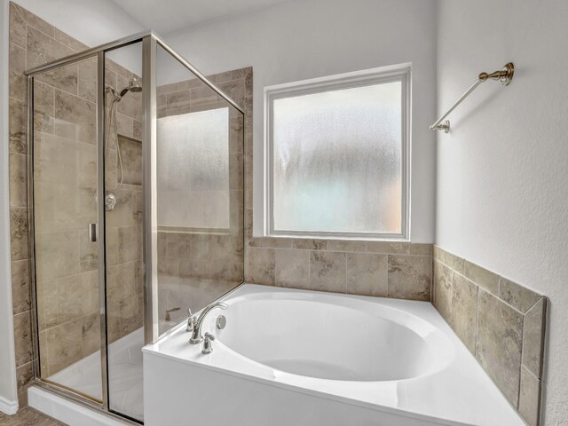 bathroom with a garden tub and a shower stall