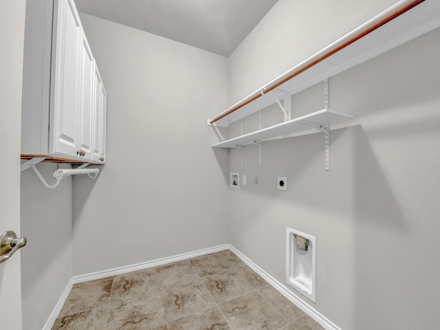 clothes washing area with washer hookup, hookup for an electric dryer, cabinet space, and baseboards