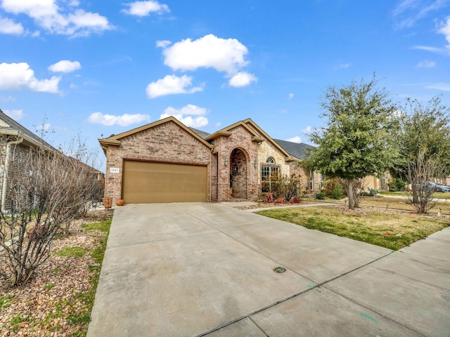 view of front of home with a garage, concrete driveway, and brick siding