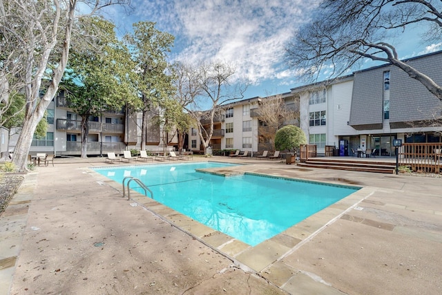 community pool with a patio area