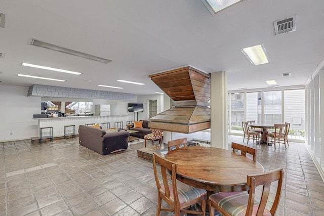 dining space with a wall of windows and visible vents