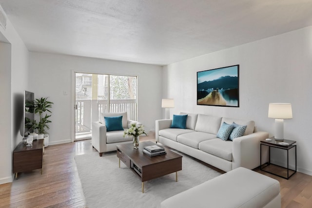 living area featuring wood finished floors and baseboards