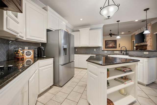 kitchen with white cabinets, stainless steel fridge, a sink, and open shelves