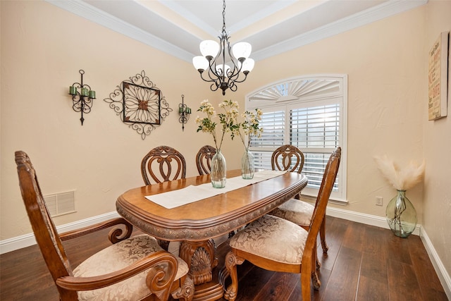 dining area featuring baseboards, visible vents, a raised ceiling, hardwood / wood-style floors, and a chandelier