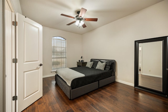 bedroom with ceiling fan, dark wood finished floors, and baseboards