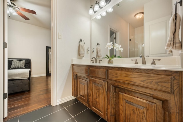 bathroom with a sink, visible vents, a ceiling fan, tile patterned floors, and double vanity