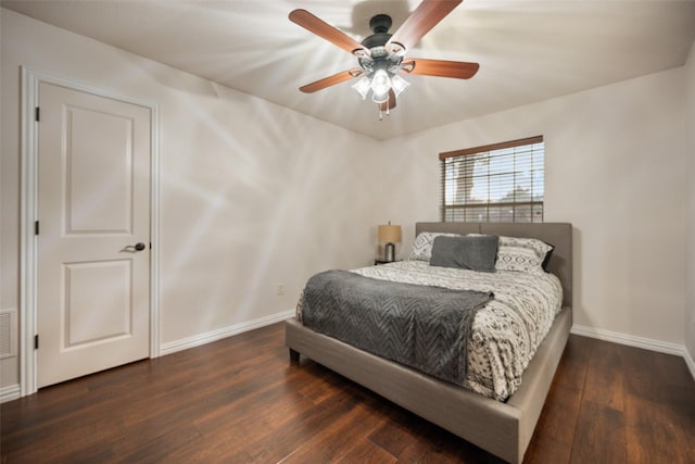 bedroom with hardwood / wood-style flooring, ceiling fan, and baseboards