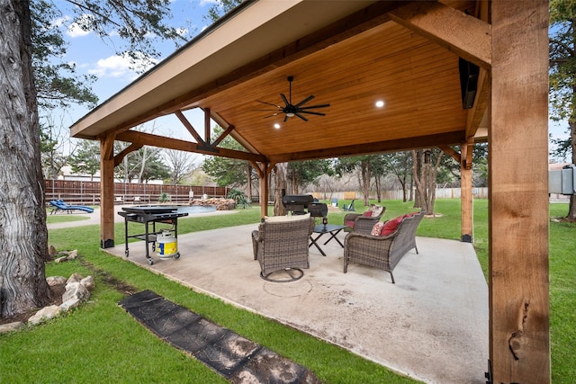 view of patio featuring an outdoor hangout area, a gazebo, fence, and a ceiling fan