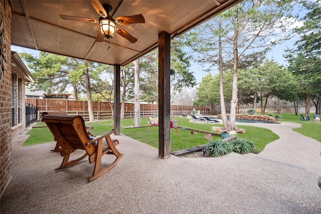 exterior space with a fenced backyard and a ceiling fan