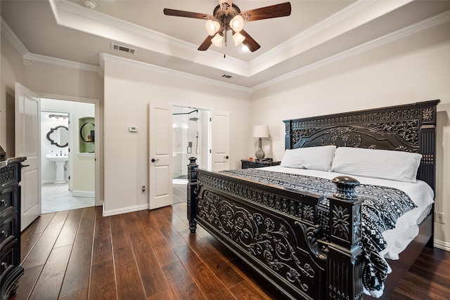 bedroom with a raised ceiling, visible vents, and wood-type flooring