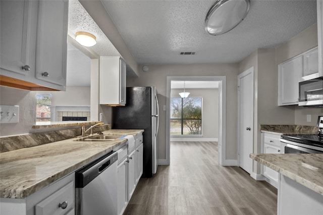 kitchen with appliances with stainless steel finishes and white cabinets