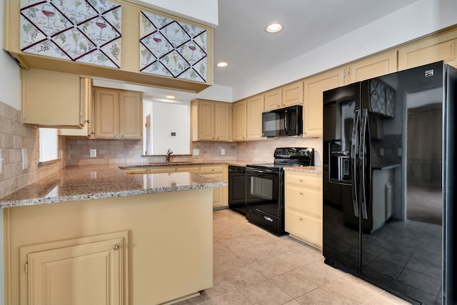 kitchen featuring cream cabinets, recessed lighting, a sink, backsplash, and black appliances