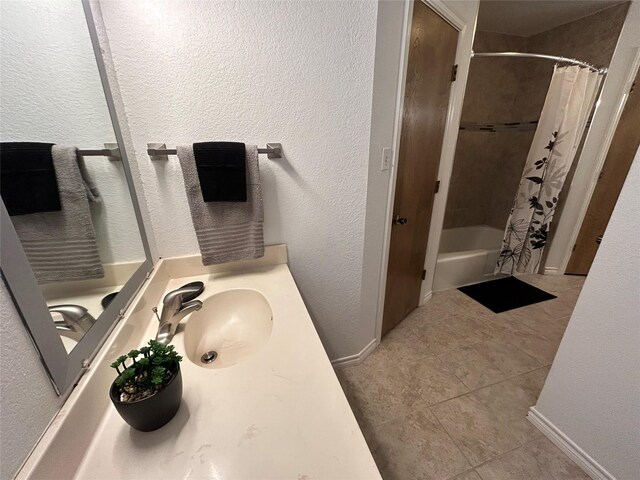 full bath featuring vanity, baseboards, shower / bath combination with curtain, and tile patterned floors