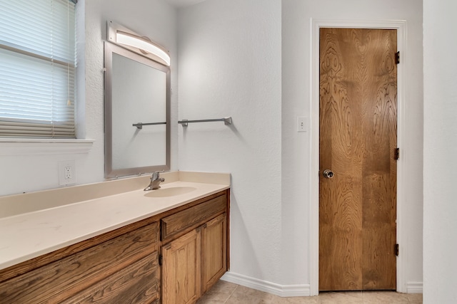 bathroom featuring tile patterned flooring, vanity, and baseboards