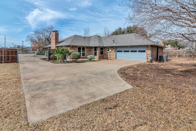 ranch-style home featuring driveway, a chimney, an attached garage, fence, and central air condition unit